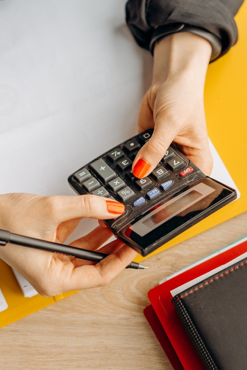 A Person Using a Calculator in Computing