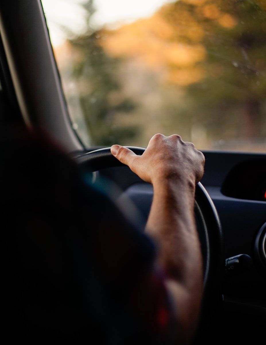 person driving car during daytime