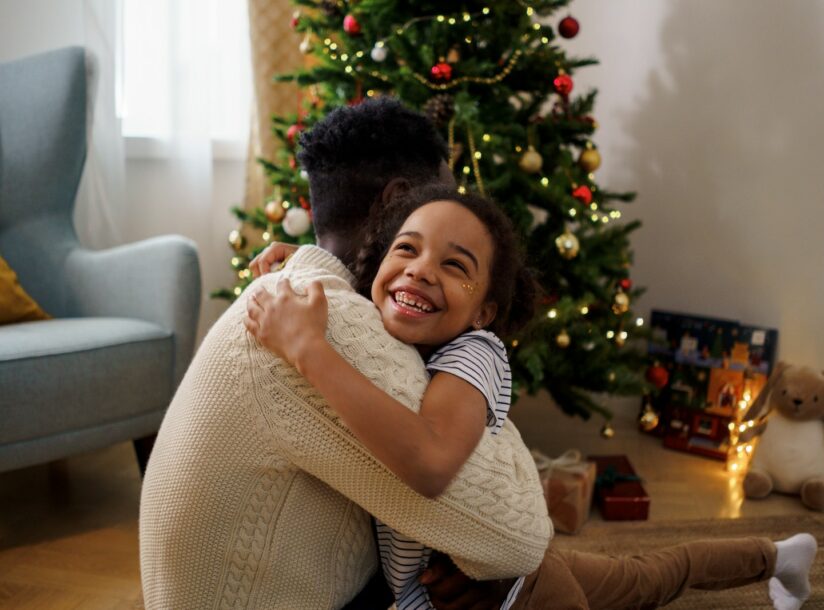 Dad and Daughter Hugging Each Other While Smiling