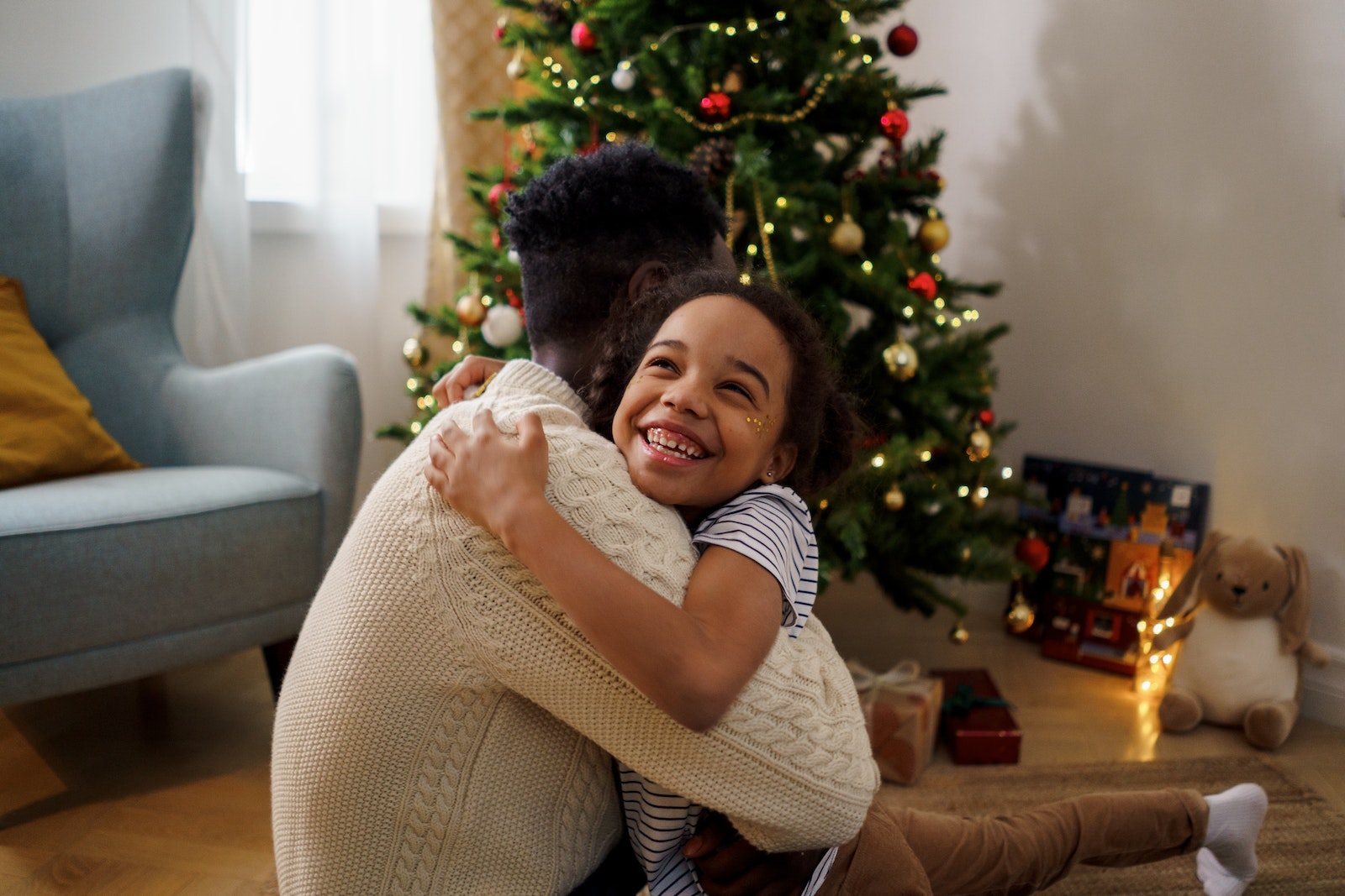 Dad and Daughter Hugging Each Other While Smiling