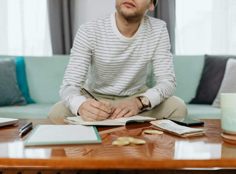 Man in White and Gray Striped Long Sleeve Shirt Sitting at the Table